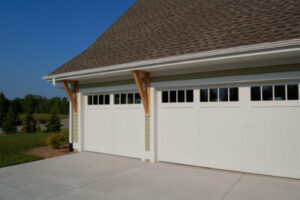 two large, white garage doors on a home