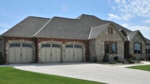 large mansion home with three attractive garage doors