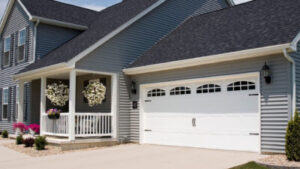 close view of large, white garage doors on a grey suburban home