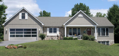 charming suburban home with large, stylish garage door